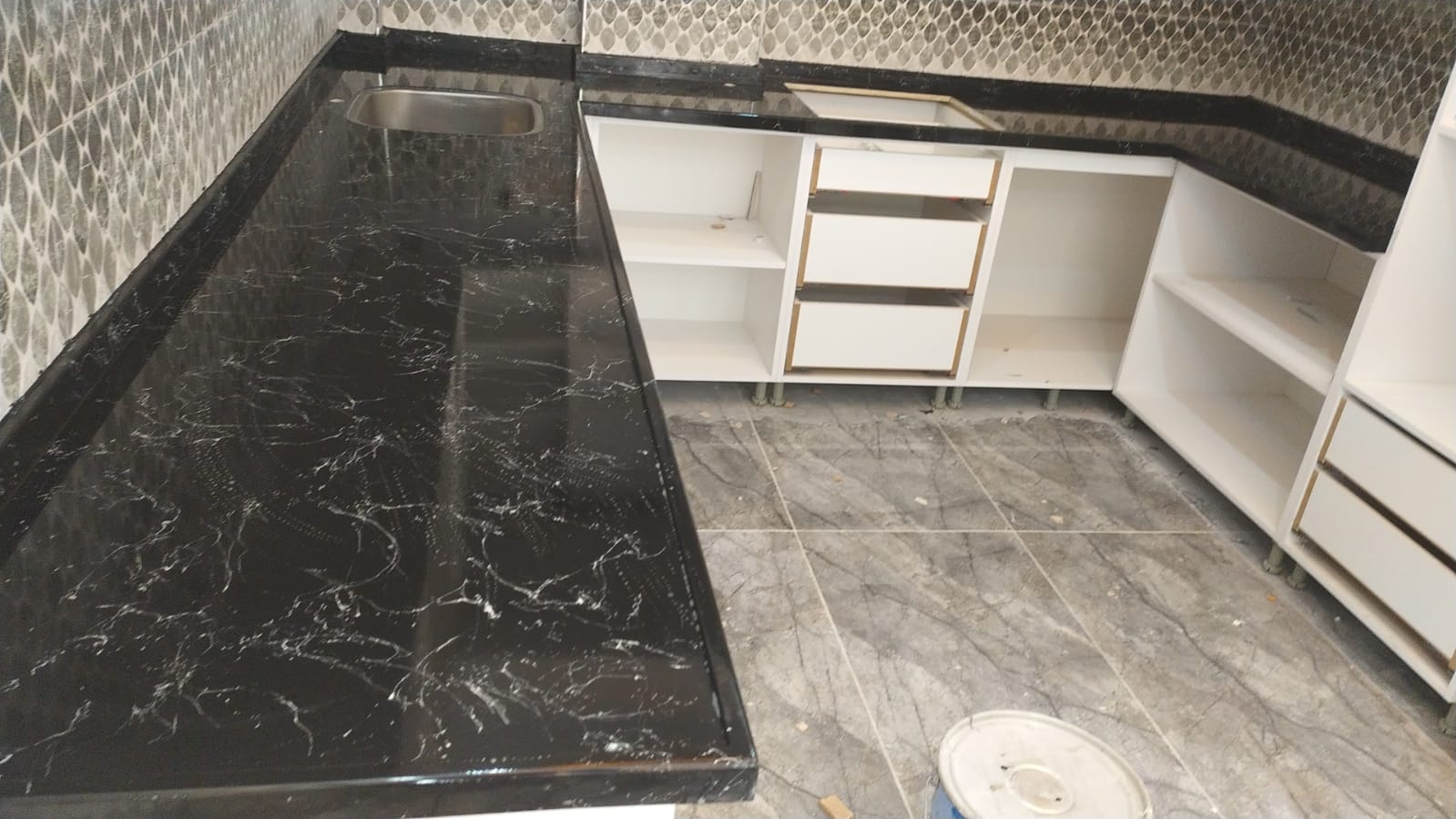 Siyah zemin, beyaz damarlı mermerit L tezgah ve arkalık